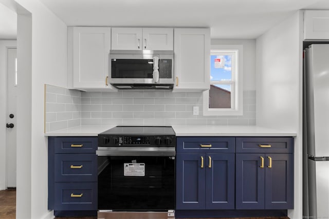 kitchen with stainless steel appliances, white cabinets, decorative backsplash, and blue cabinets