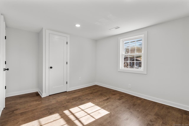 unfurnished room featuring dark wood-type flooring