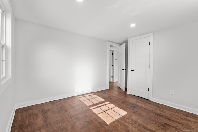 empty room with dark wood-type flooring