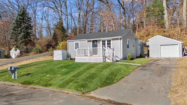 bungalow-style home with an outbuilding, a garage, and a front lawn