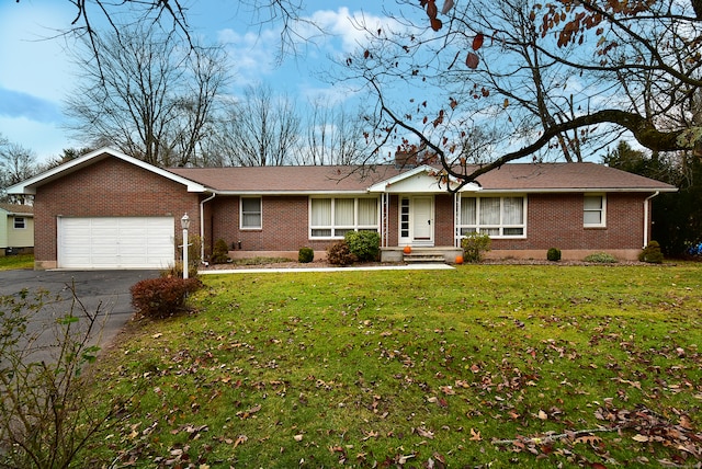 single story home with a front yard and a garage