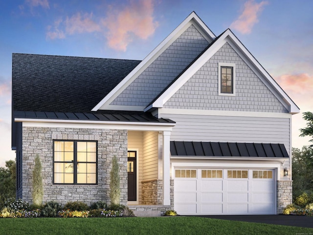 view of front of home with a garage and a lawn