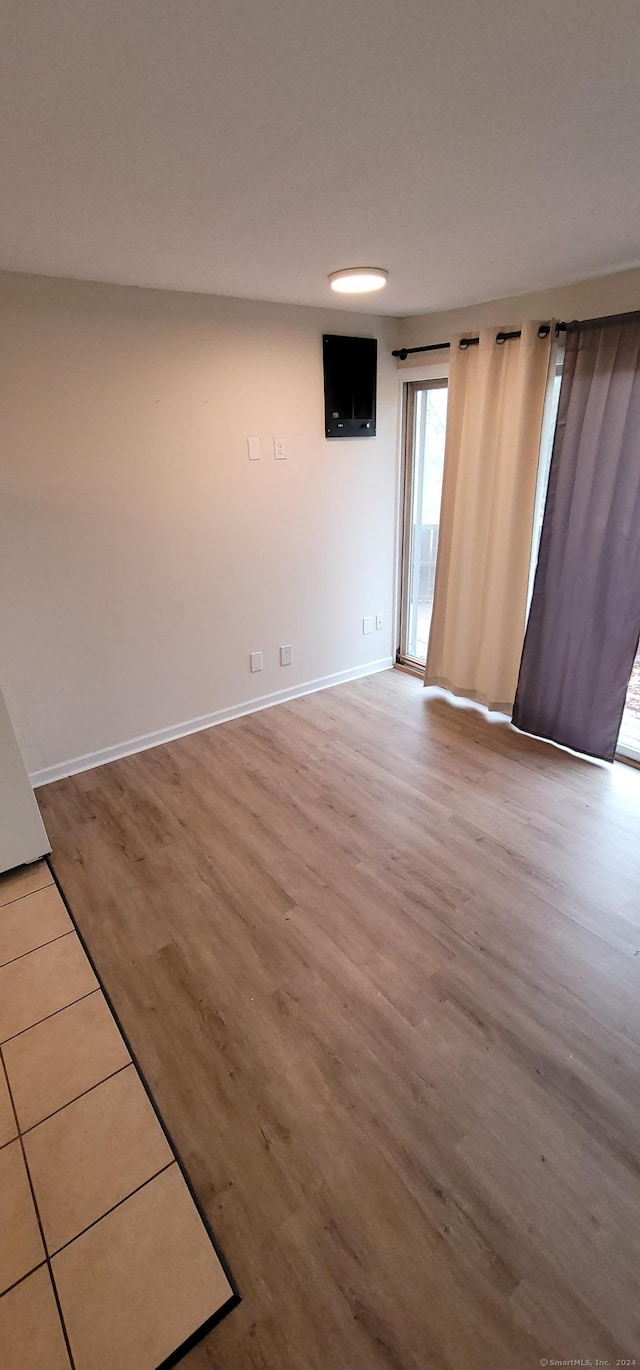 spare room with light hardwood / wood-style flooring