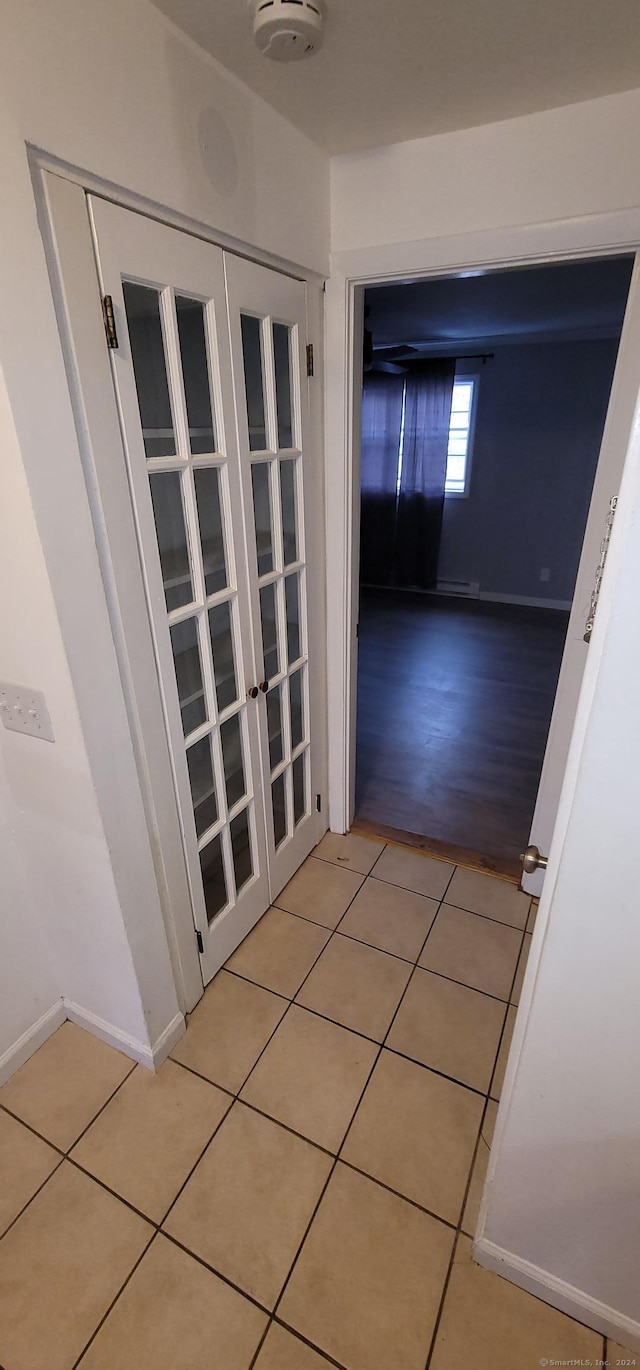 corridor with light hardwood / wood-style floors