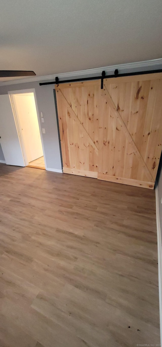 empty room featuring hardwood / wood-style floors and a barn door