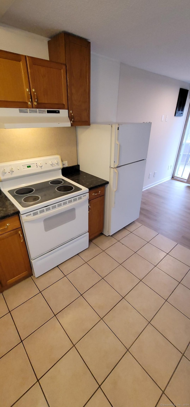 kitchen featuring white appliances and light hardwood / wood-style floors