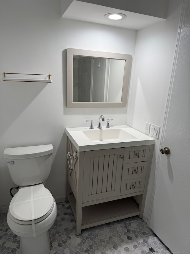 bathroom with vanity, tile patterned floors, and toilet