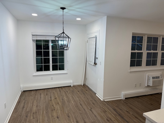 unfurnished dining area featuring a baseboard heating unit, a wall unit AC, and dark wood-type flooring