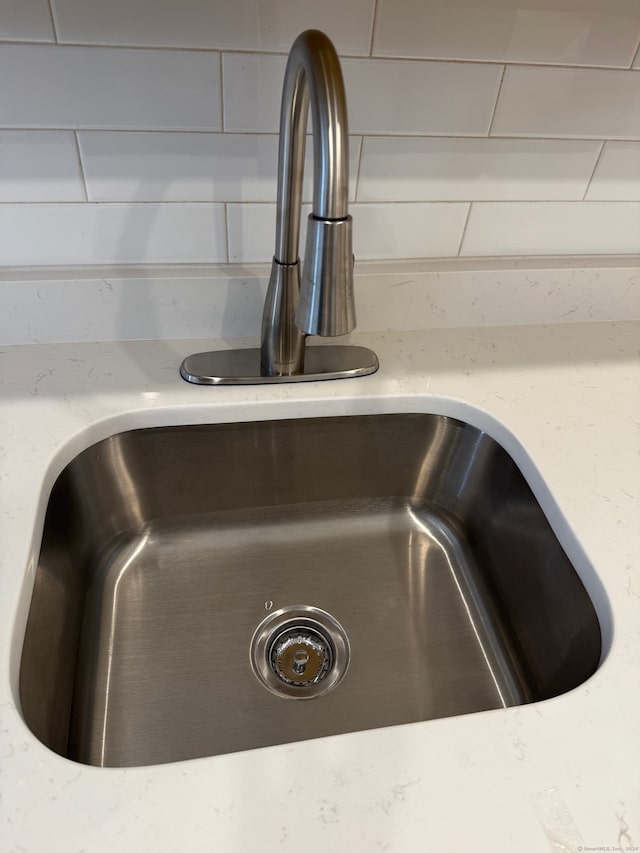 details featuring sink and light stone counters