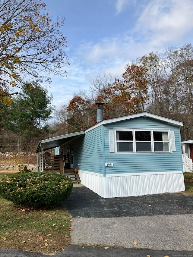 view of side of property featuring a carport