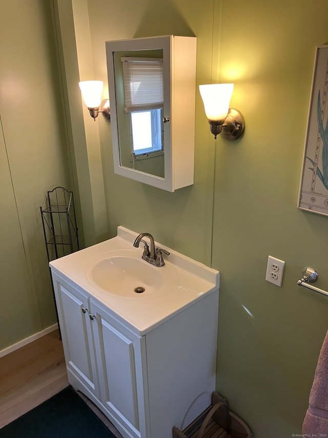 bathroom with vanity and hardwood / wood-style flooring