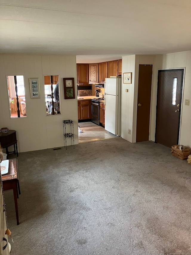 unfurnished living room featuring light carpet