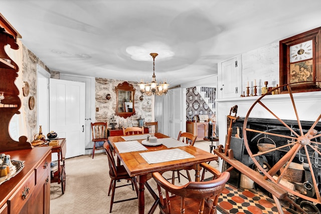 dining area with light carpet and a notable chandelier