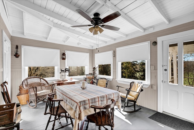 sunroom / solarium featuring a wealth of natural light, ceiling fan, and vaulted ceiling with beams