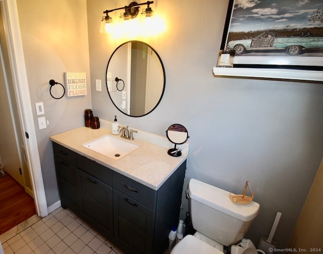 bathroom with tile patterned floors, vanity, and toilet