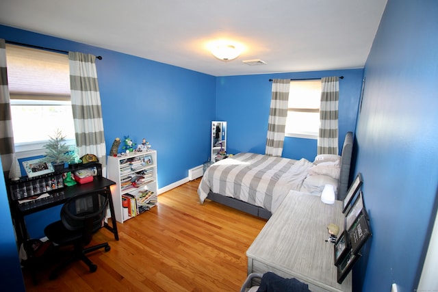 bedroom with wood-type flooring