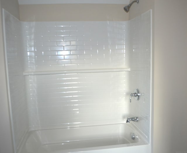 bathroom with washtub / shower combination