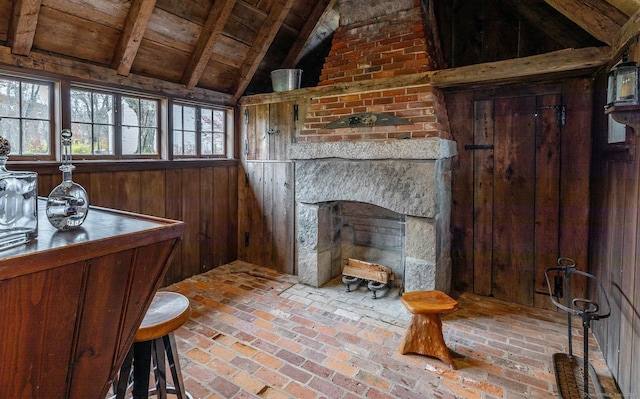 living area with wooden ceiling, wood walls, brick flooring, and a fireplace