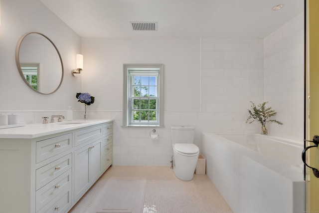 full bath with vanity, tile walls, a bath, and tile patterned floors