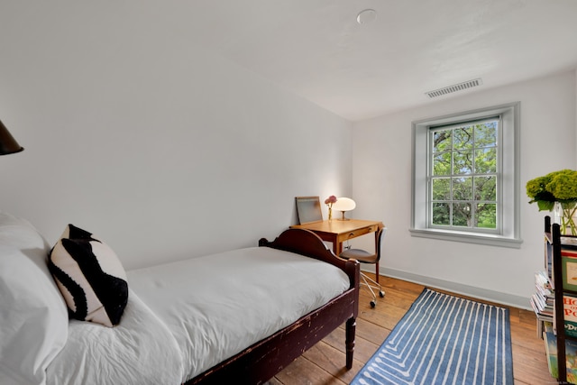 bedroom featuring baseboards and light wood-type flooring
