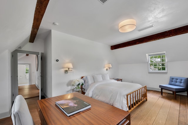 bedroom featuring hardwood / wood-style floors and baseboards