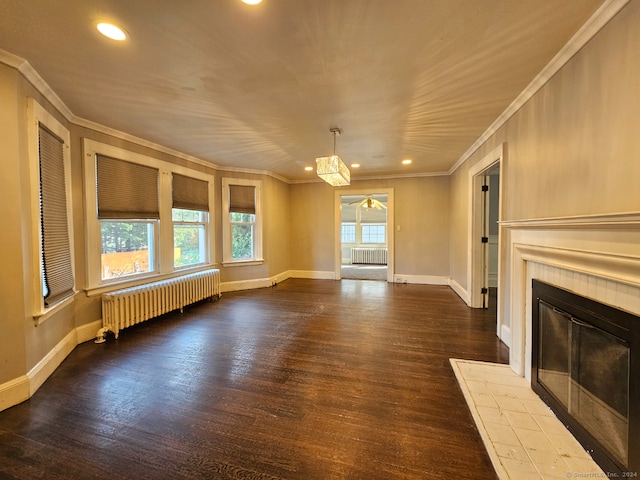 unfurnished living room featuring radiator heating unit, hardwood / wood-style floors, and a fireplace