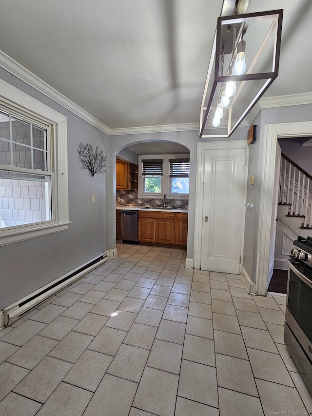 kitchen with appliances with stainless steel finishes, decorative backsplash, baseboard heating, and crown molding