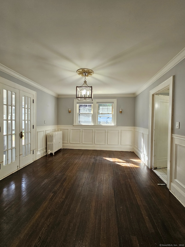 interior space with french doors, radiator, a chandelier, ornamental molding, and dark hardwood / wood-style floors