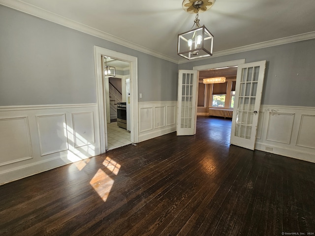 unfurnished dining area with radiator heating unit, french doors, ornamental molding, dark hardwood / wood-style flooring, and an inviting chandelier