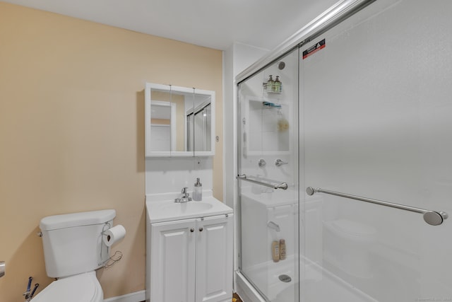 bathroom featuring vanity, toilet, and an enclosed shower