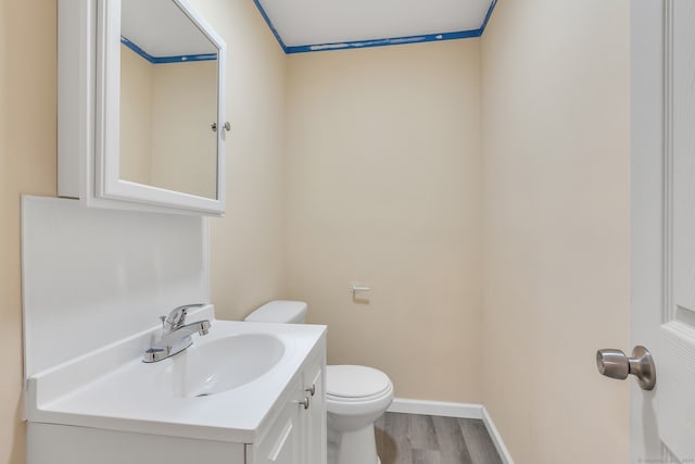 bathroom with vanity, hardwood / wood-style flooring, and toilet