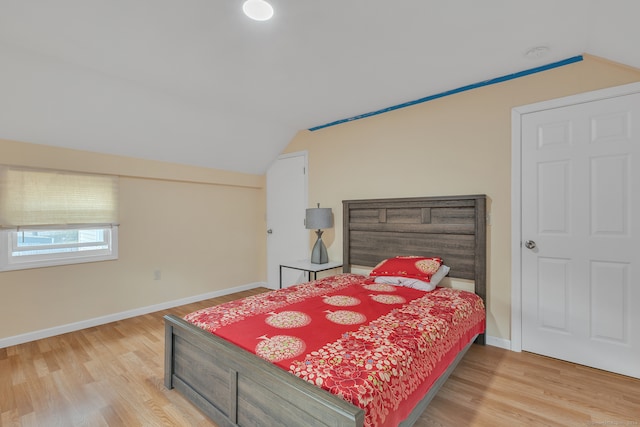 bedroom featuring lofted ceiling and wood-type flooring