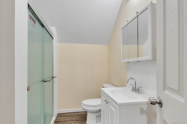 bathroom featuring a shower with door, vanity, hardwood / wood-style flooring, toilet, and lofted ceiling