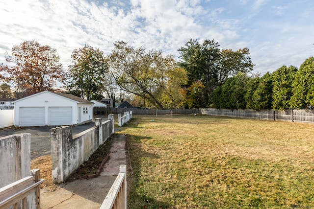 view of yard with a garage and an outdoor structure