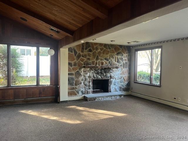 39 Rockefeller Ave, West Haven, CT 06516 - unfurnished living room with carpet, plenty of natural light, a stone fireplace, and wood ceiling