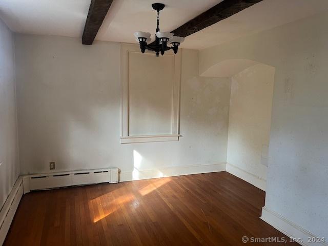 39 Rockefeller Ave, West Haven, CT 06516 - unfurnished room with beam ceiling, hardwood / wood-style floors, a chandelier, arched walkways, and baseboards