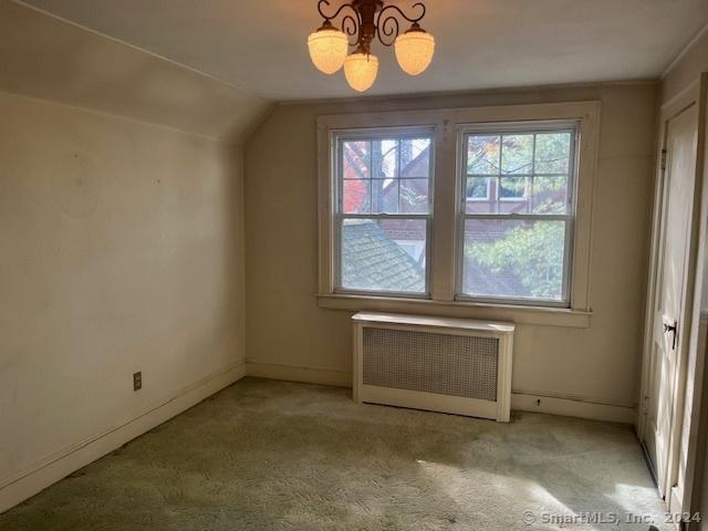 39 Rockefeller Ave, West Haven, CT 06516 - bonus room with radiator, carpet floors, lofted ceiling, a chandelier, and baseboards