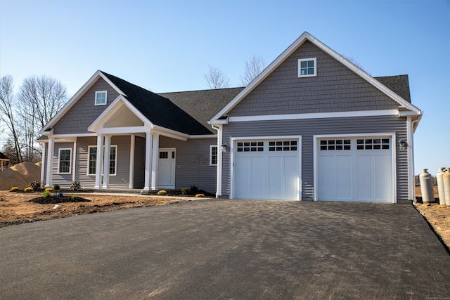 craftsman-style home featuring a garage and a porch