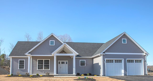 view of front facade with a garage and covered porch