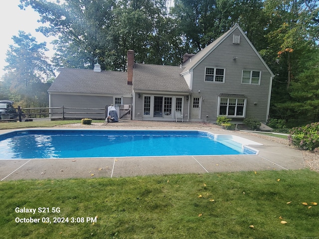 view of swimming pool with a lawn and a patio area