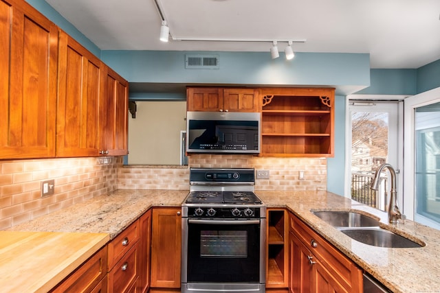 kitchen with visible vents, appliances with stainless steel finishes, a sink, open shelves, and backsplash