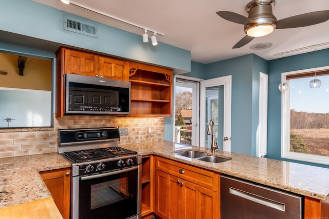 kitchen featuring visible vents, appliances with stainless steel finishes, a peninsula, open shelves, and a sink