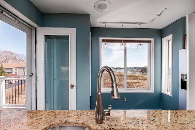 interior space featuring rail lighting and vanity