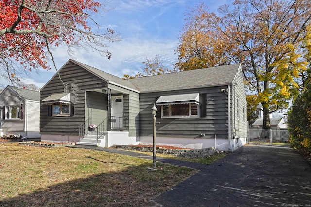 bungalow-style home featuring a front yard