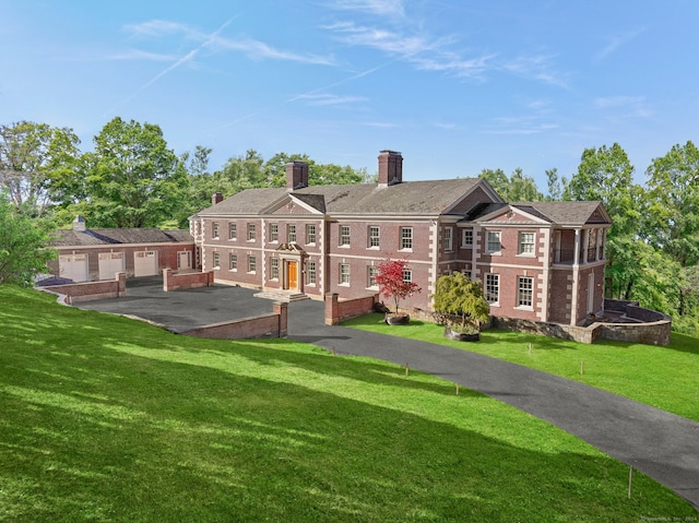 rear view of house featuring a lawn