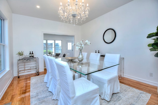 dining area featuring a notable chandelier and light hardwood / wood-style flooring