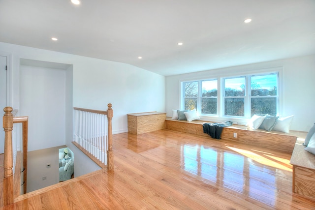 unfurnished room featuring light hardwood / wood-style floors and vaulted ceiling