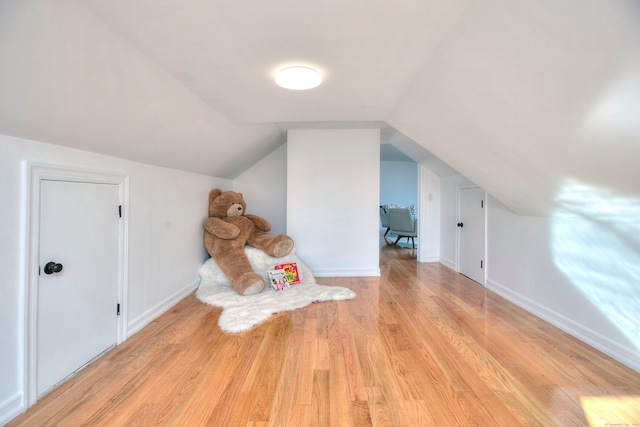 bonus room featuring light hardwood / wood-style flooring and vaulted ceiling