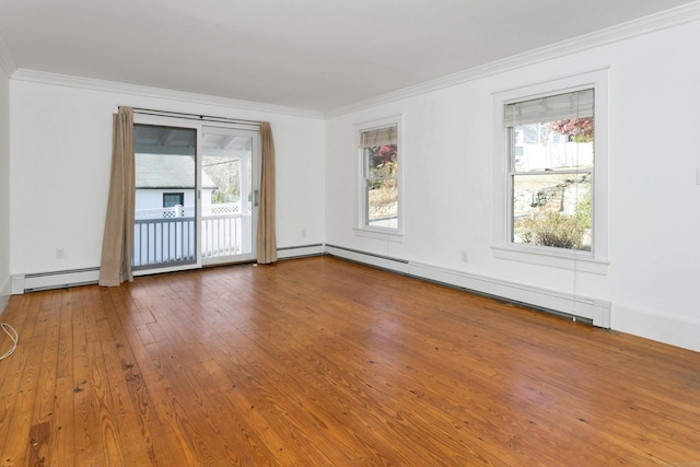 empty room with plenty of natural light, hardwood / wood-style floors, a baseboard radiator, and ornamental molding