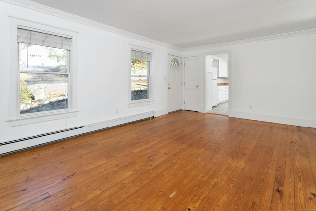 empty room with light hardwood / wood-style flooring, a healthy amount of sunlight, and a baseboard radiator